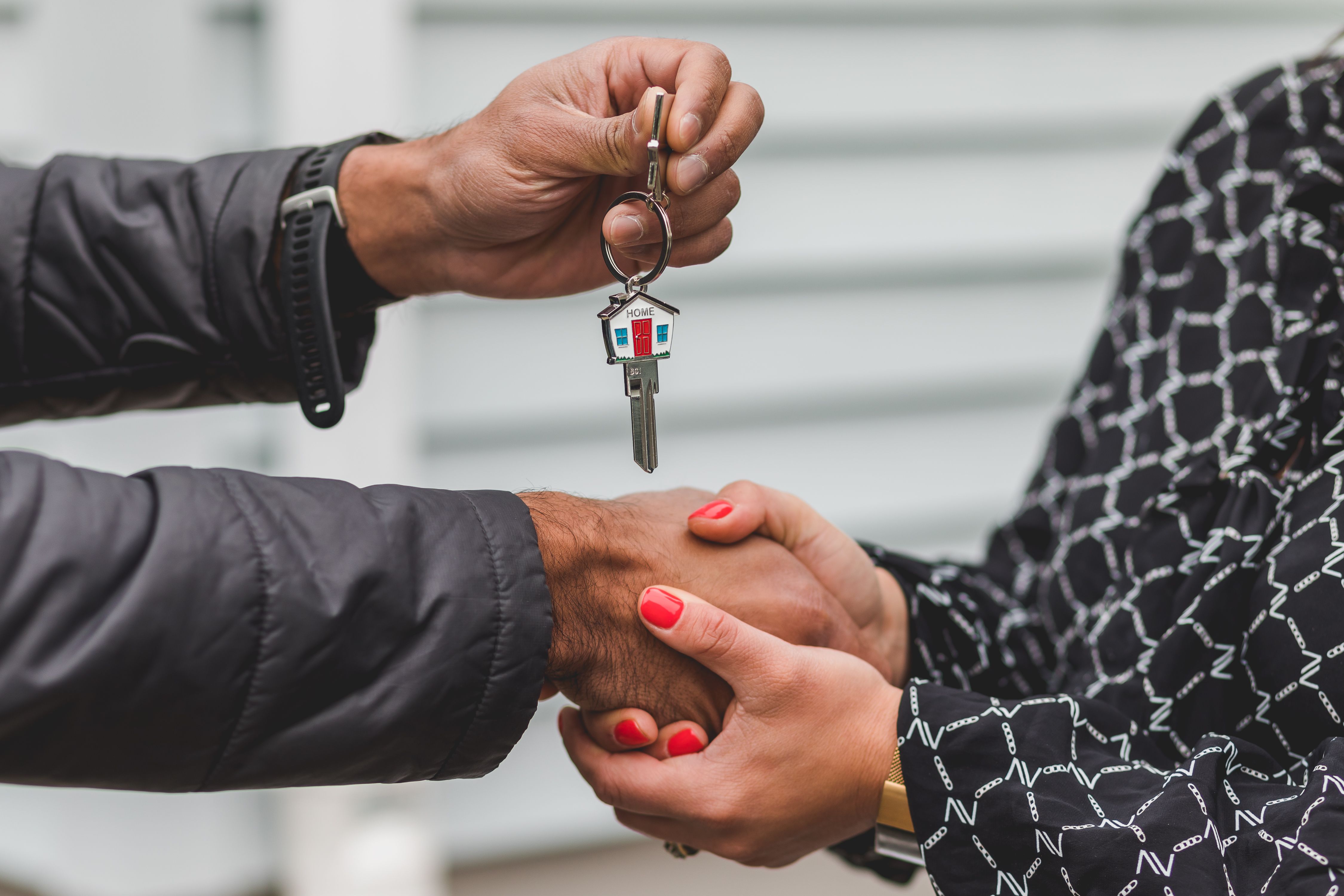 Realtor handing over house keys on closing day